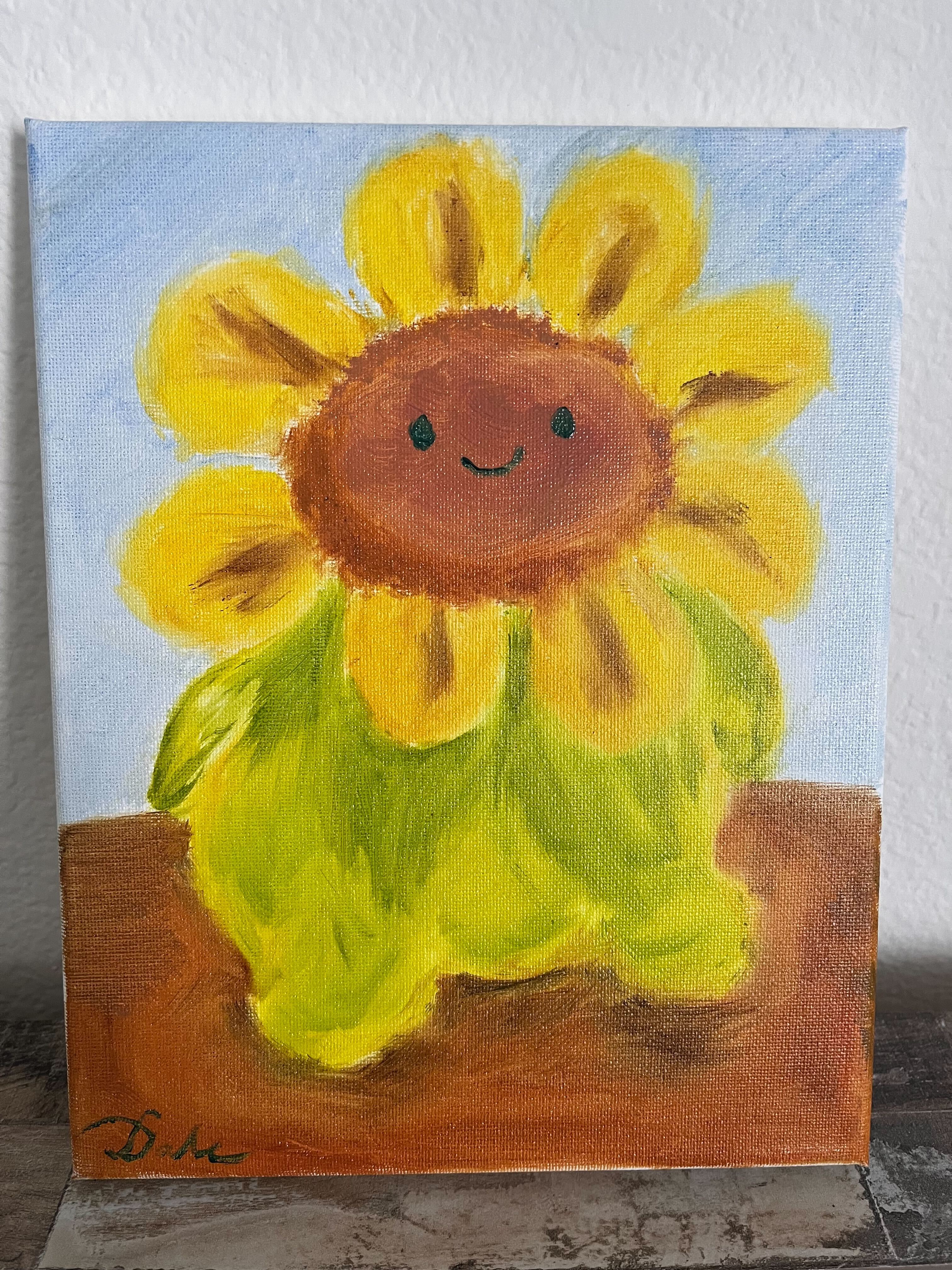 Flower plush with yellow petals, plump green body, and a big smile