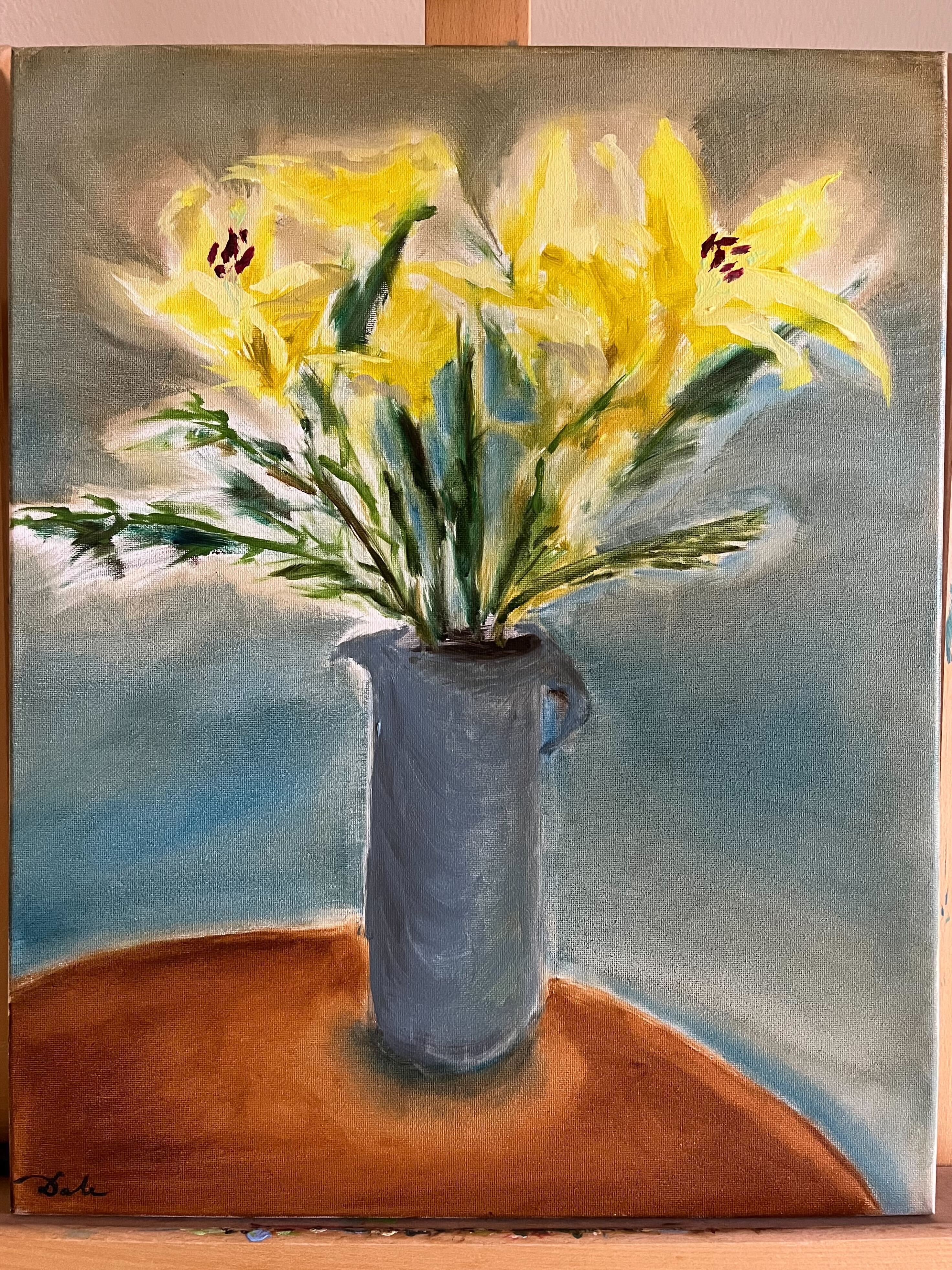 Yellow flowers in a bluish grey vase